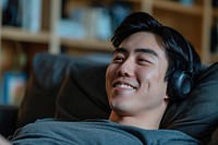 Asian man headphones smile happy.