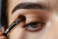 Woman close eyes with a brush using makeup cosmetics perfection forehead. AI generated Image by rawpixel.