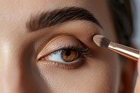 Woman close eyes with a brush using makeup cosmetics perfection forehead. AI generated Image by rawpixel.