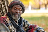 Homeless man sitting in the park adult homelessness hopelessness.