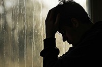 Silhouette of man depressed worried adult hand.