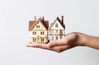  Hand holding a model house finger white background neighbourhood. AI generated Image by rawpixel.