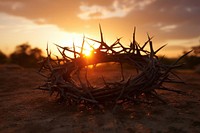 Silhouette of cross and crown of thorns on the ground sunset sunlight outdoors. AI generated Image by rawpixel.