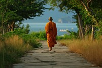 Buddhist monk walking in Thailand adult spirituality architecture. AI generated Image by rawpixel.