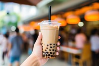 Hand holding a bubble tea drink adult cup. AI generated Image by rawpixel.