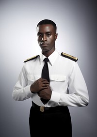 Black man wearing white ship captain uniform portrait adult accessories.