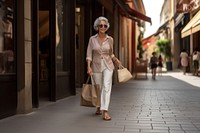 A smart looking old Latin woman walking with shopping bag adult architecture accessories.