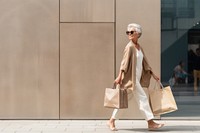A smart looking old Latin woman walking with shopping bag handbag adult architecture.