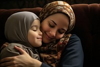 Muslim mother hugging son adult affectionate togetherness.