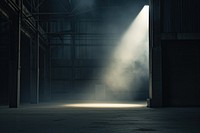 Black factory with spotlight and fog in nighttime lighting architecture illuminated.