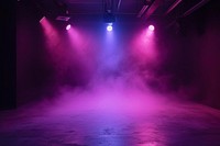 Black studio with fog violet and pink spotlights lighting stage entertainment.