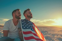 A joyful gay couple with America flags outdoors portrait adult.