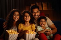 Indian Family portrait popcorn parent. AI generated Image by rawpixel.