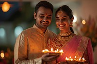 Smiling Indian couple hold Diwali diya tray festival wedding smiling. AI generated Image by rawpixel.