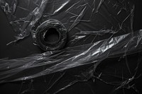 Tape with plastic wrap black backgrounds black background.