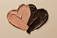 Makeup foundation swatch brown and pink brown shape heart chocolate dessert studio shot.