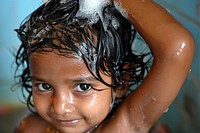 A happy kid washing hair bathing innocence happiness.