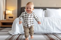 Happy baby walking in the bedroom comfortable relaxation innocence.