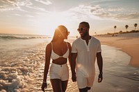 Happy black couple traveling vacation sunset beach.