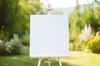 Blank white easel sign canvas outdoors absence.
