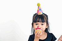 Asia girl eatting cupcake birthday portrait eating.