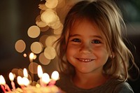 A happy american girl celebrating birthday portrait dessert candle.
