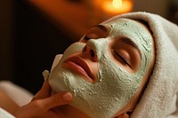 Woman getting a facial mask face spa relaxation.