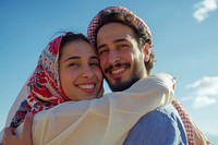 Middle eastern couple hugging smiling adult scarf.
