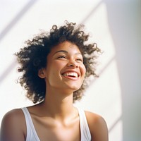 A mixed race american-african woman laughing smiling smile.