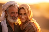 Senior Middle eastern couple taking care each other smiling sunset adult.