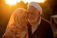 Senior Middle eastern couple taking care each other portrait smiling sunset.