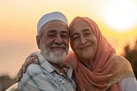 Senior Middle eastern couple taking care each other portrait outdoors smiling.