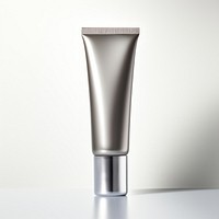 A dark silver cream tube cosmetics white background aftershave.