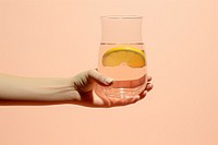 Water with orange glass holding yellow drink. AI generated Image by rawpixel.