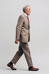 A senior man walking in studio wearing suit blazer tuxedo adult.
