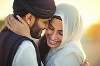 Young wealthy middle eastern couple hugging adult happy.