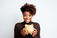 Black girl holding piggy bank portrait smile adult.