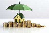 Coins and a house in white color under a green umbrella money architecture investment.