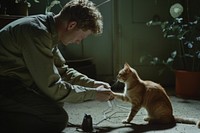 Man playing with a cat animal mammal kitten.
