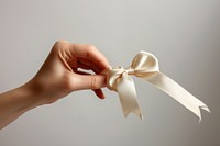 A hand holding ribbon finger.