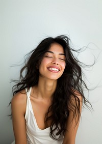 A Latina woman laughing smiling smile.