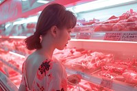 Checking different types of meat adult store woman.
