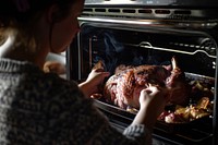Woman lifting meat out of oven appliance cooking adult.
