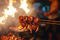 Octopus grill on stick grilling cooking food.