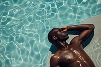 African american man sunbathing adult pool bodybuilding.