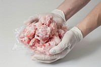 Hands holding meat clots glove food pink.