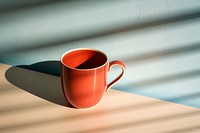 A hot chocolate cup shadow coffee drink.