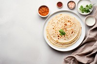 A White beige minimalistic photography of Dosas in cook book style pancake bread food.