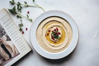 A White beige minimalistic photography of hummus in cook book style plate food meal.