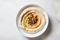 A White beige minimalistic photography of hummus in cook book style bread plate food.